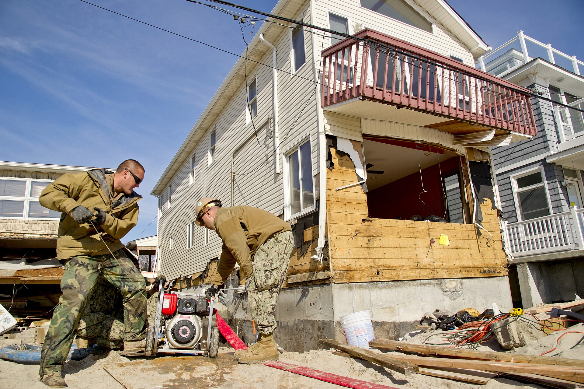 Water being pumped out of a flooded residential basement